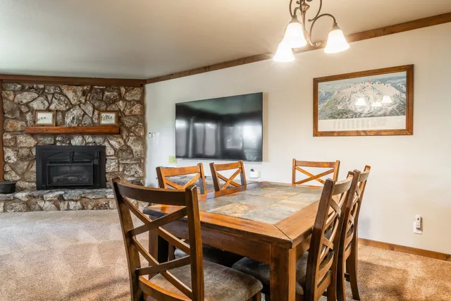 a view of a dining room with furniture and a fireplace
