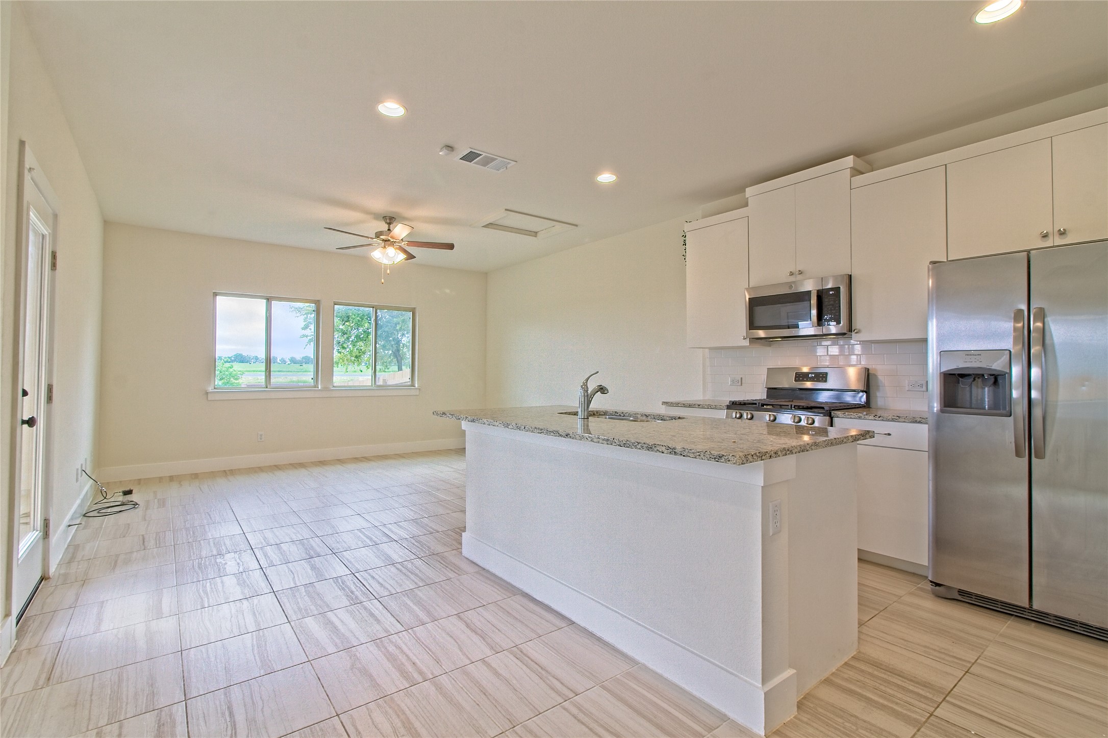555 White Steppe Way Georgetown, TX 78626 - Photo 8 of 40 a kitchen with stainless steel appliances a refrigerator sink and microwave