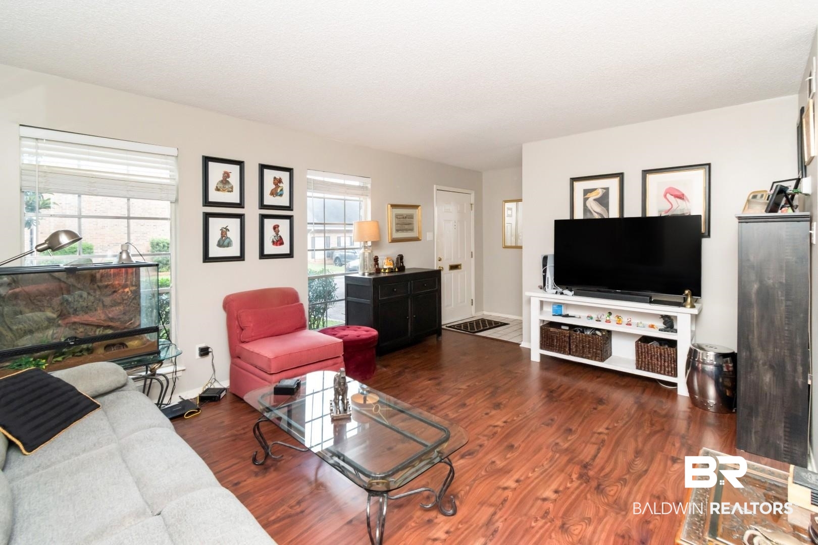 118 Du Rhu Drive, Unit H Mobile, AL 36608 - Photo 5 of 19 Living area featuring wood-finish flooring, light-toned walls, and multiple windows