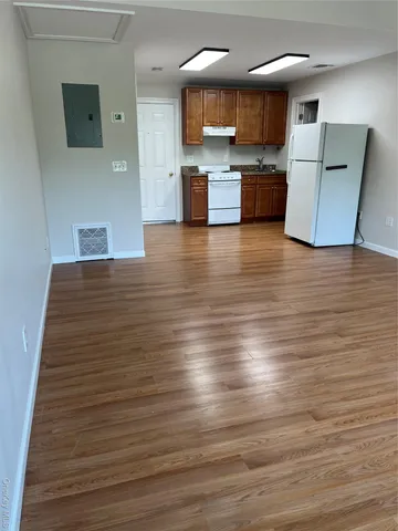 a view of kitchen with cabinets and wooden floor