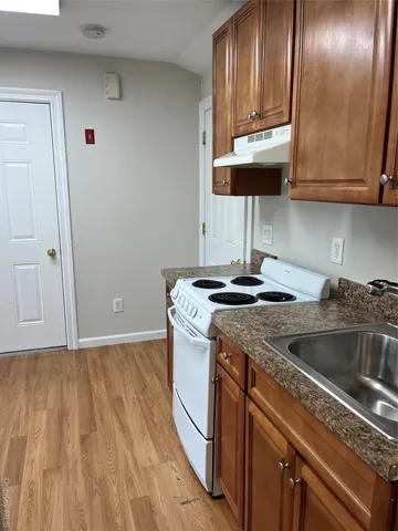a kitchen with a sink cabinets and stainless steel appliances