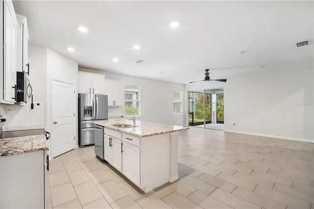 a kitchen with stainless steel appliances granite countertop a stove and a refrigerator