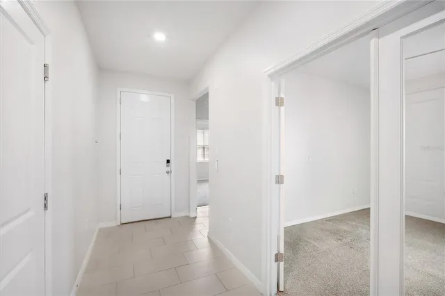 a view of a hallway to rooms