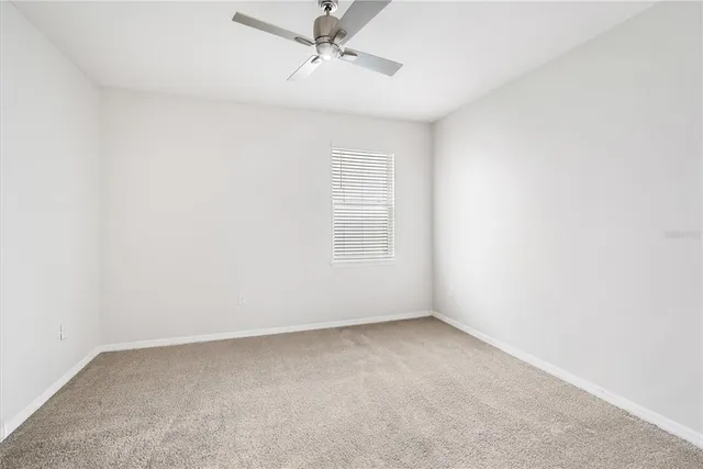 an empty room with a empty space and a ceiling fan