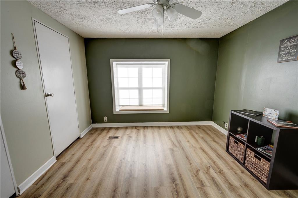 960 McEntyre Loop Calhoun, GA 30701 - Photo 23 of 77 a view of an empty room with a window and wooden floor