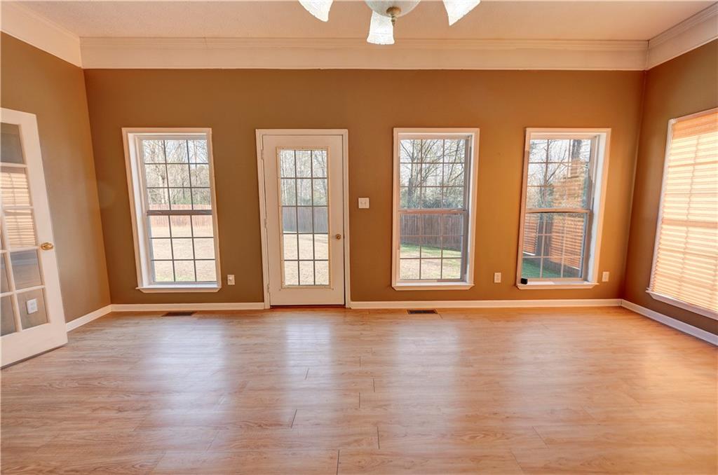 960 McEntyre Loop Calhoun, GA 30701 - Photo 28 of 77 a view of an empty room with wooden floor and a window