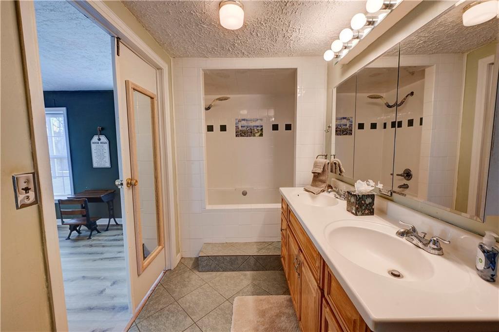 960 McEntyre Loop Calhoun, GA 30701 - Photo 33 of 77 a bathroom with a sink a toilet and a large mirror