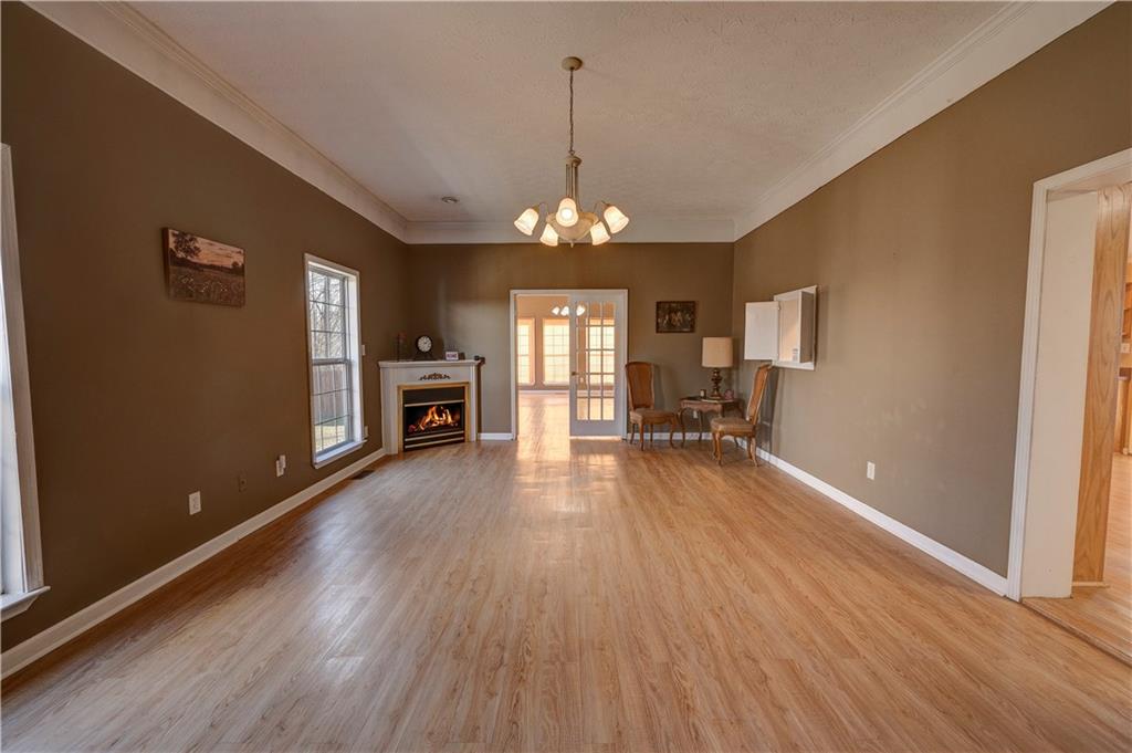 960 McEntyre Loop Calhoun, GA 30701 - Photo 5 of 77 a view of a room with wooden floor fireplace and windows