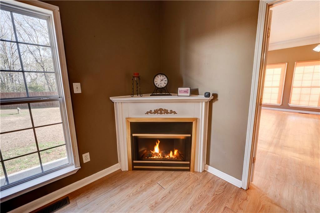 960 McEntyre Loop Calhoun, GA 30701 - Photo 6 of 77 a view of an empty room with wooden floor fireplace and a window