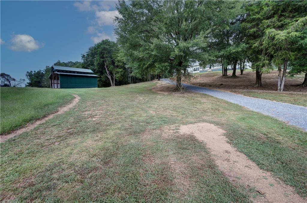 960 McEntyre Loop Calhoun, GA 30701 - Photo 67 of 77 a view of a yard with a fountain and a large tree