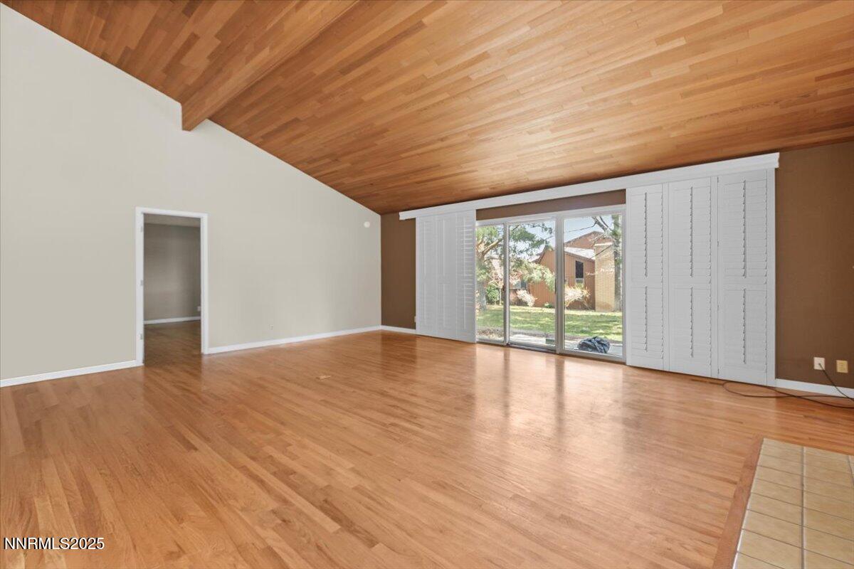 2108 Chicory Way Reno, NV 89509 - Photo 4 of 21 a view of an empty room with wooden floor and a window