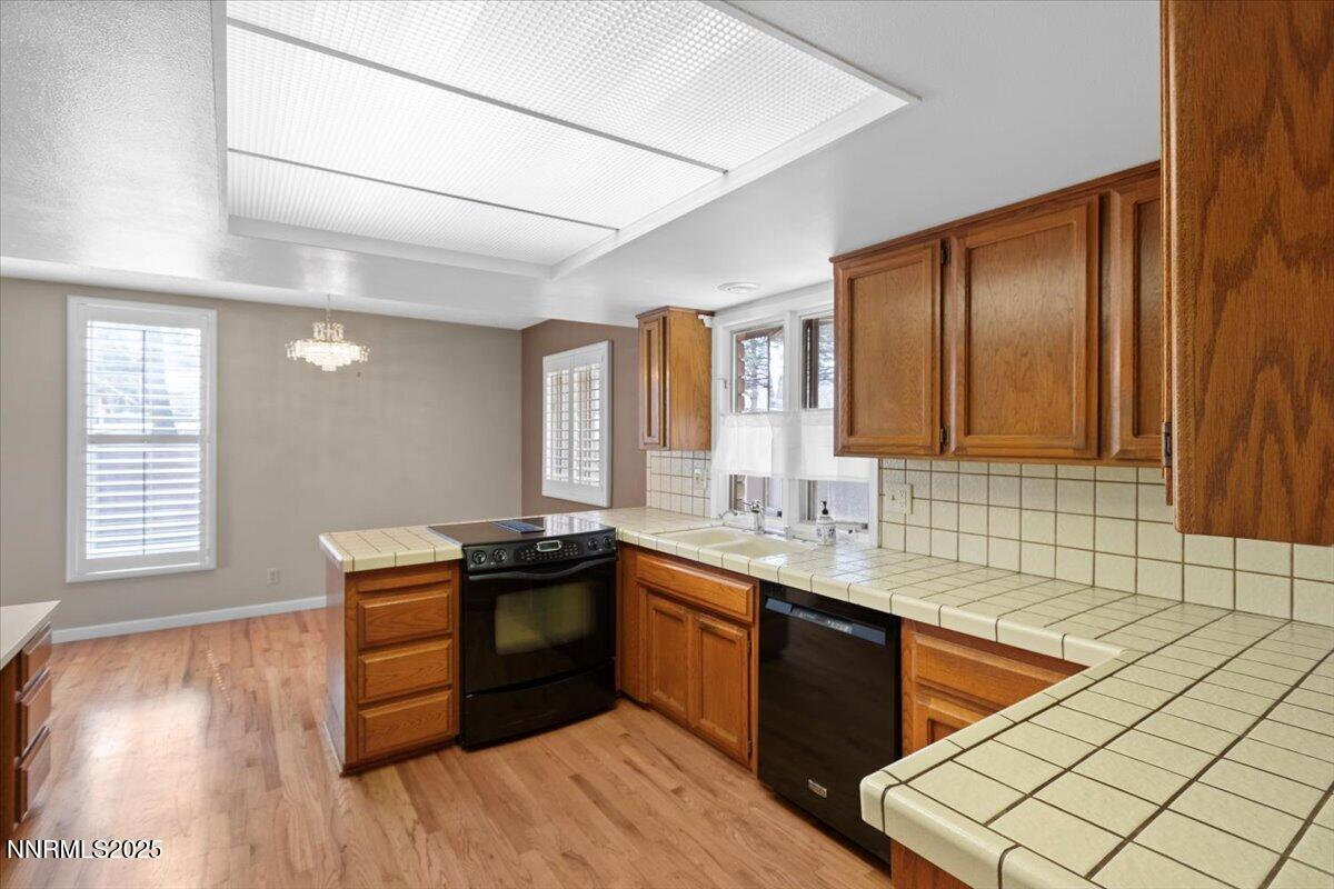 2108 Chicory Way Reno, NV 89509 - Photo 7 of 21 a kitchen with stainless steel appliances granite countertop a sink stove and cabinets