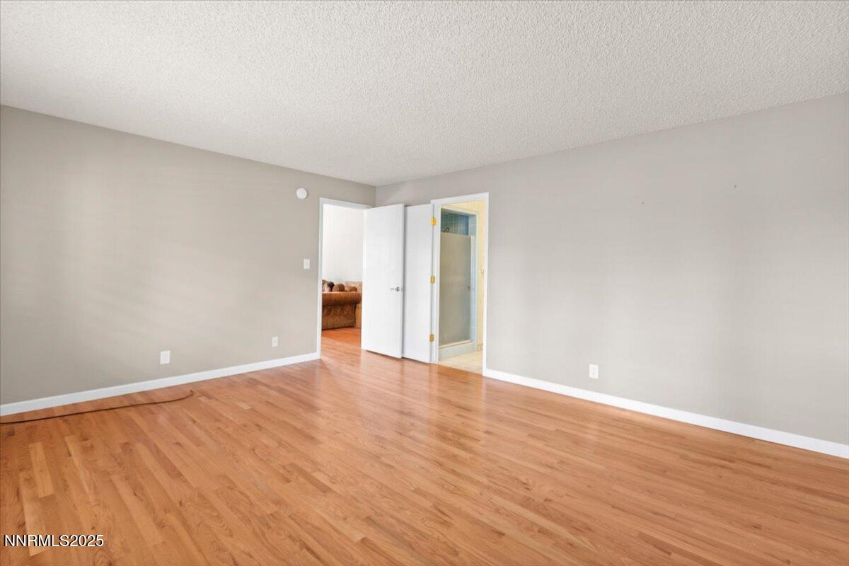 2108 Chicory Way Reno, NV 89509 - Photo 9 of 21 a view of an empty room with wooden floor