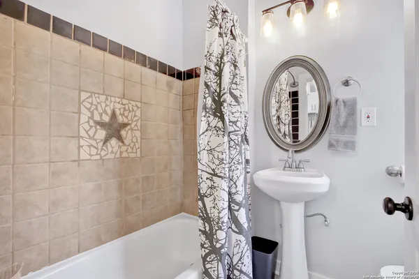 a bathroom with a sink a mirror and shower