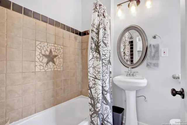 a bathroom with a sink a mirror and shower