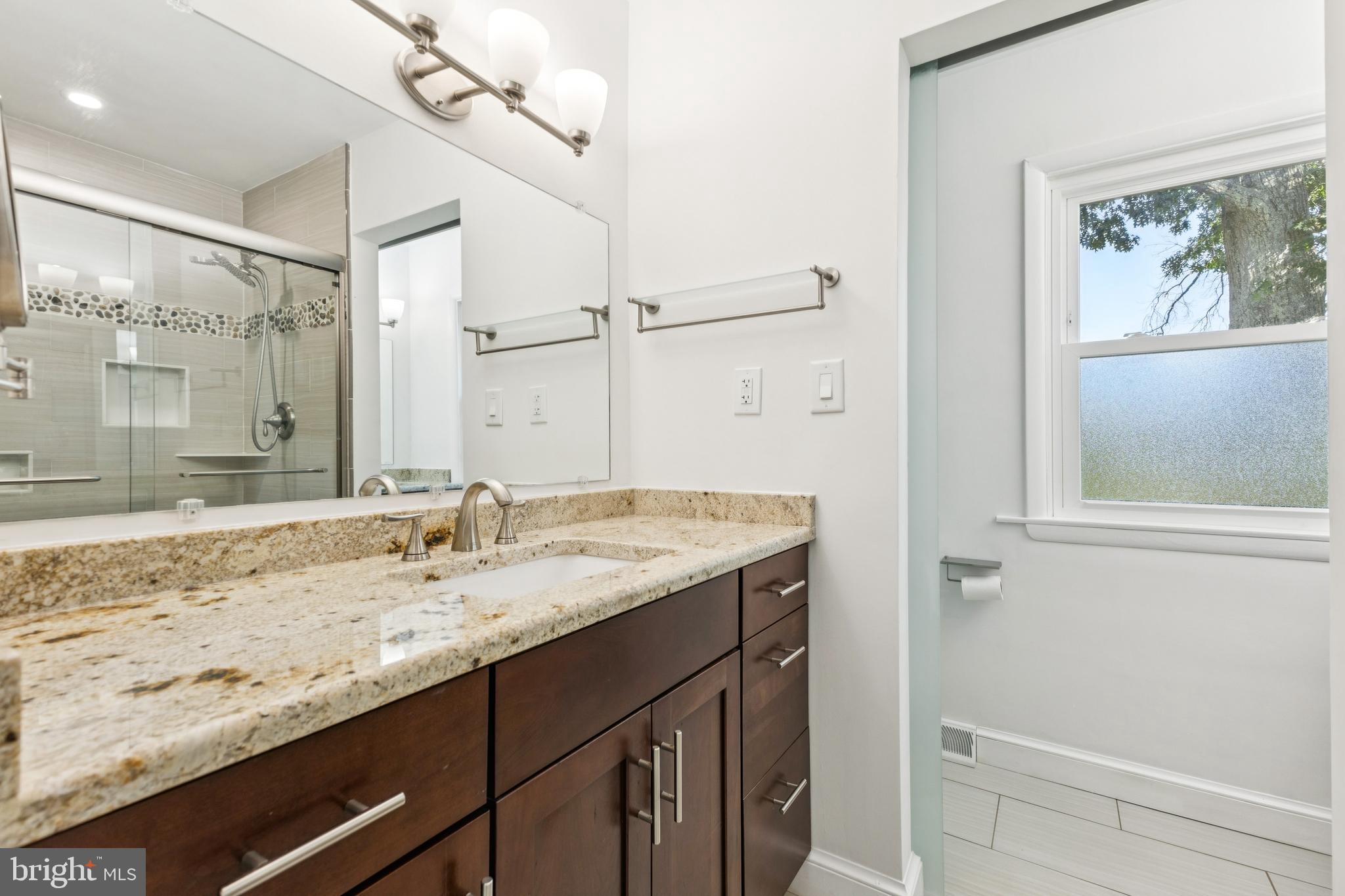 22810 Ridge Road Clarksburg, MD 20871 - Photo 21 of 44 a bathroom with a granite countertop sink mirror and vanity