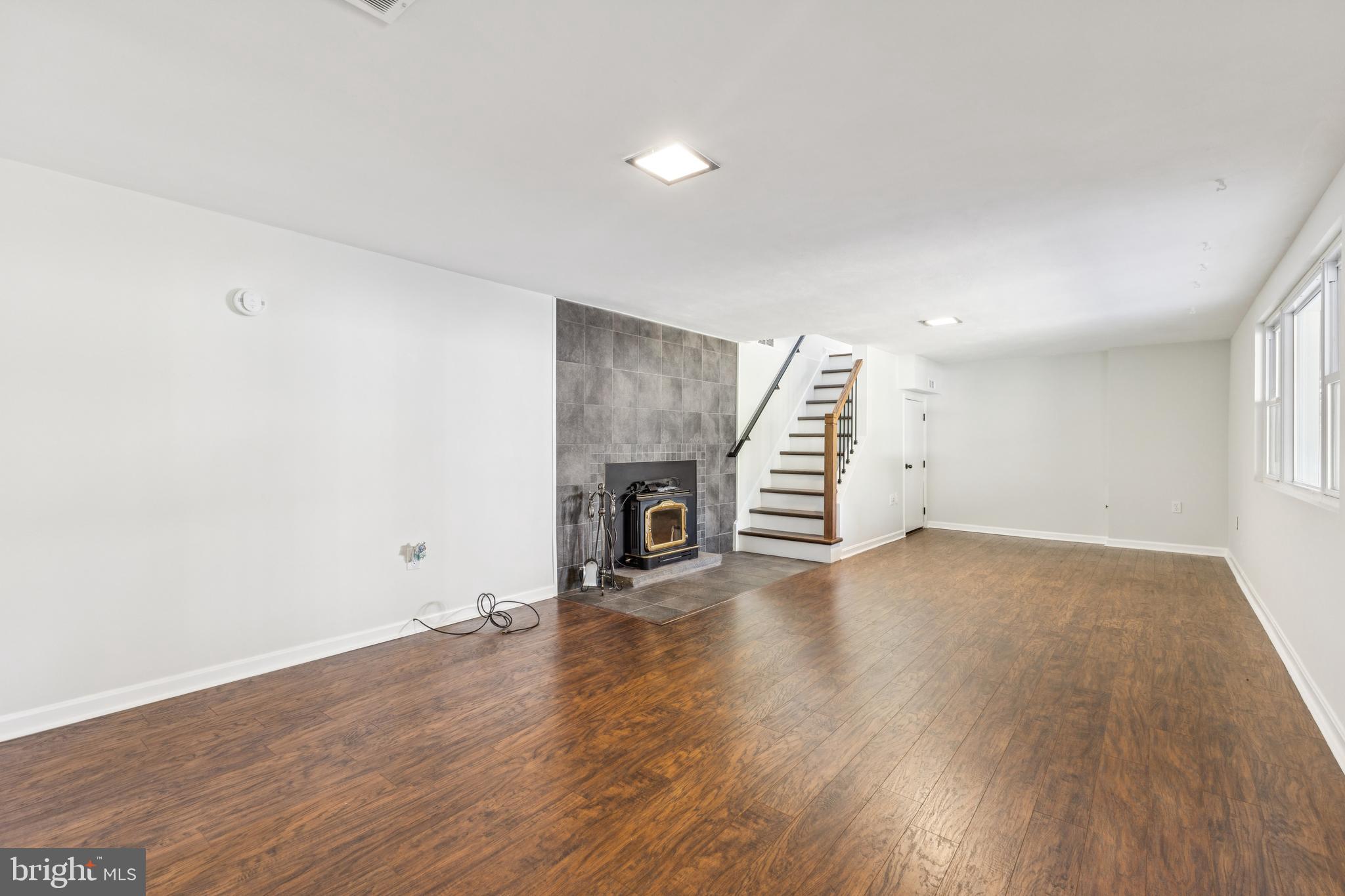 22810 Ridge Road Clarksburg, MD 20871 - Photo 26 of 44 an empty room with wooden floor and fireplace