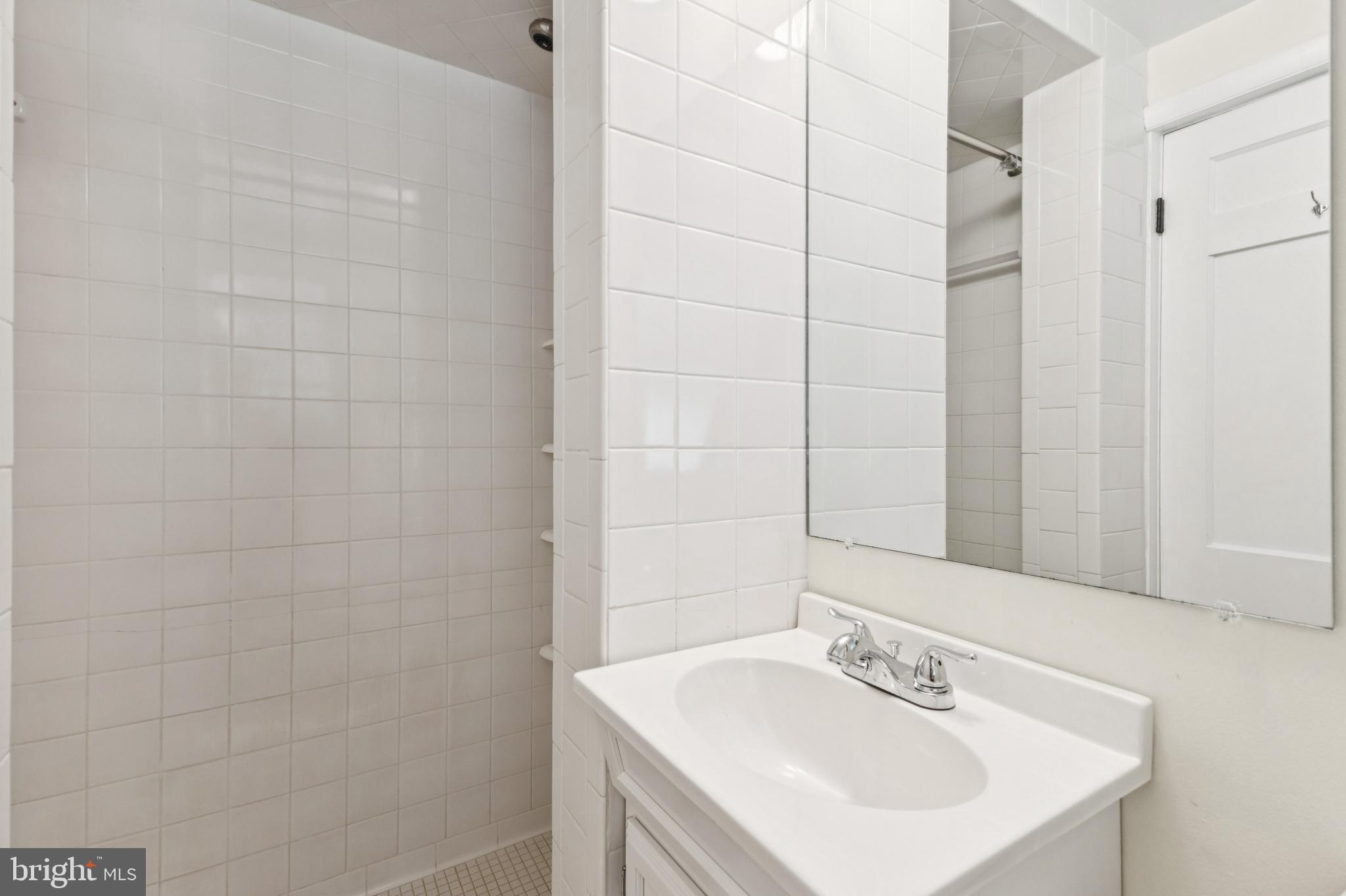 22810 Ridge Road Clarksburg, MD 20871 - Photo 31 of 44 a bathroom with a sink a shower and a mirror