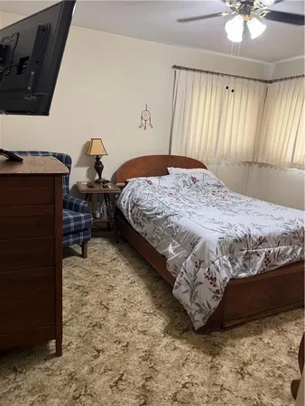 a bedroom with a bed and window