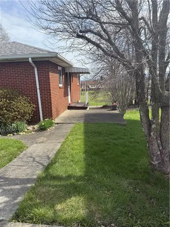 a front view of house with yard and green space