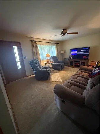a living room with furniture a window and a flat screen tv