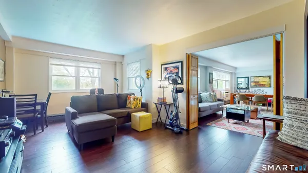 a living room with furniture and a wooden floor