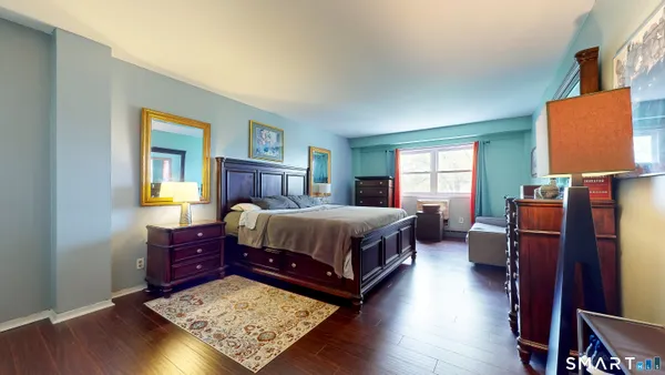 a living room with a bed furniture and a window