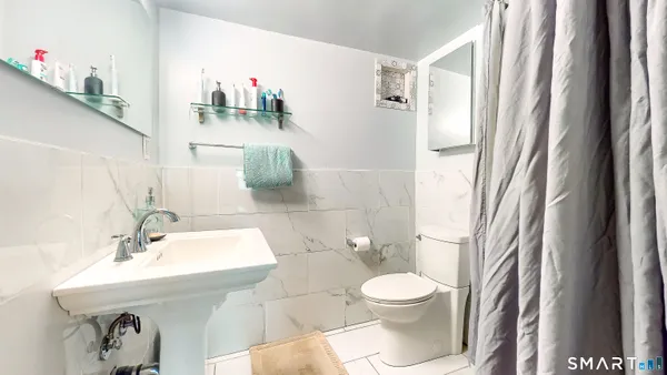 a bathroom with a sink mirror and toilet