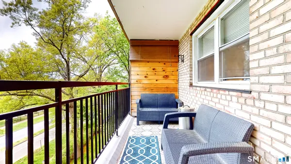 a balcony view with a seating space