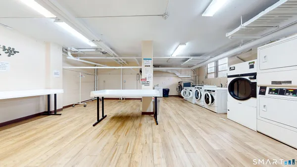 a view of a kitchen with a microwave and furniture