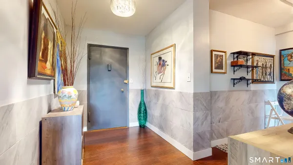 a view of an entryway with wooden floor