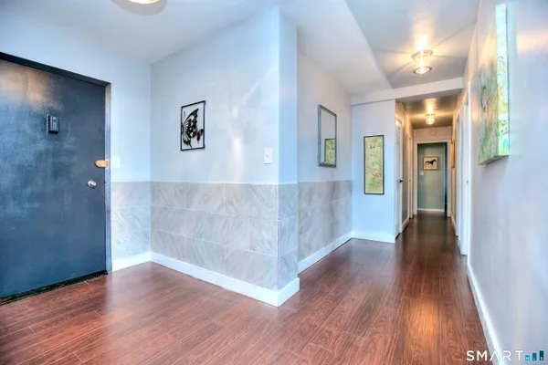 a view of hallway with wooden floor