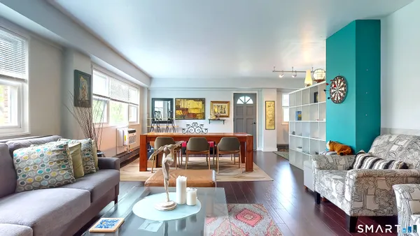 a living room with furniture and wooden floor