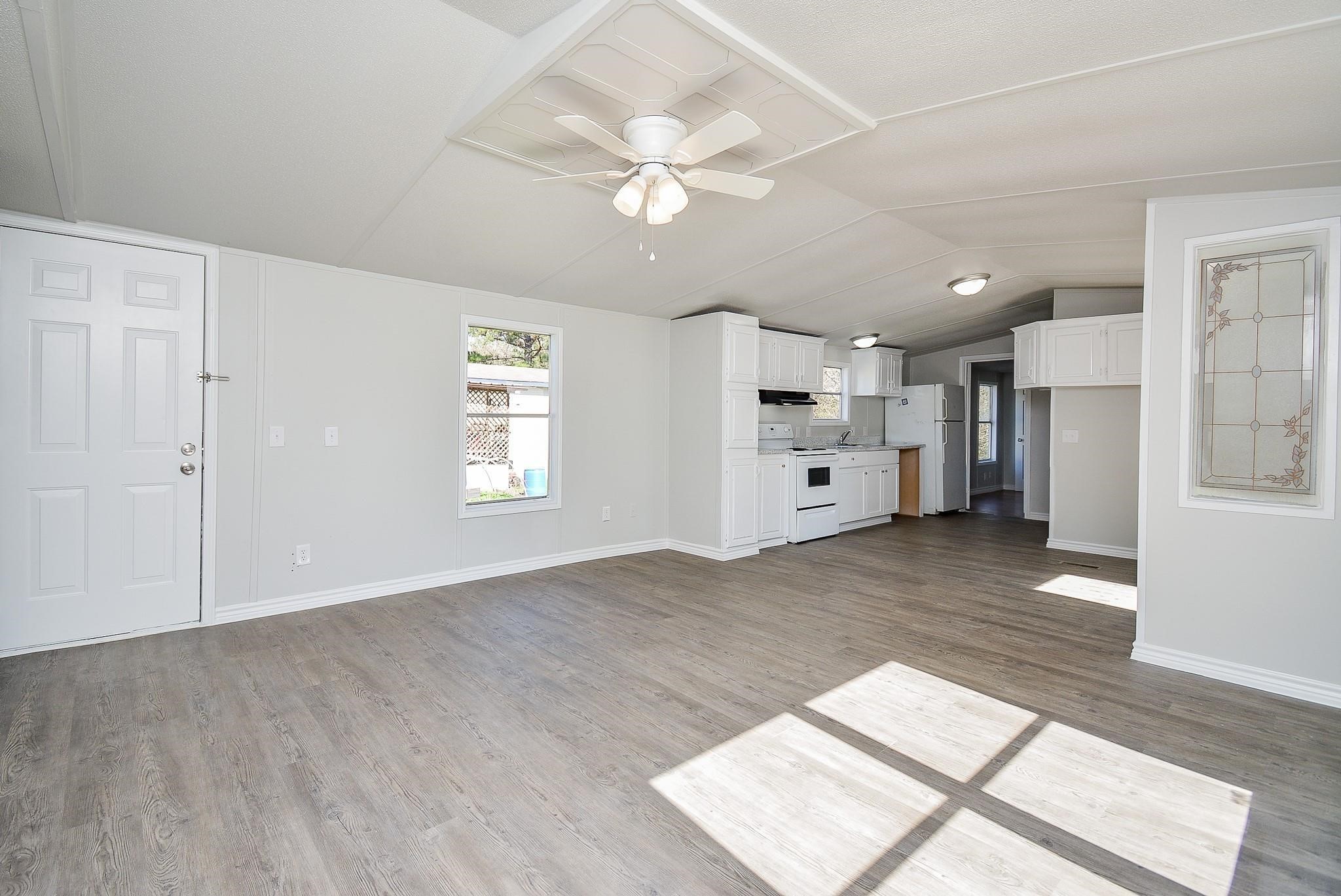 12561 Roy Harris Loop Conroe, TX 77306 - Photo 12 of 31 a view of a kitchen with a sink and a refrigerator