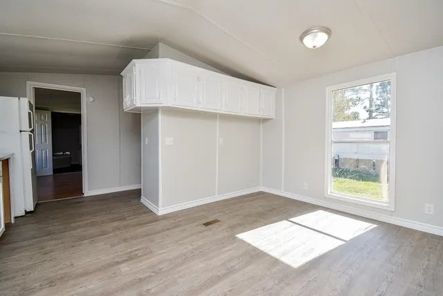 an empty room with windows and closet