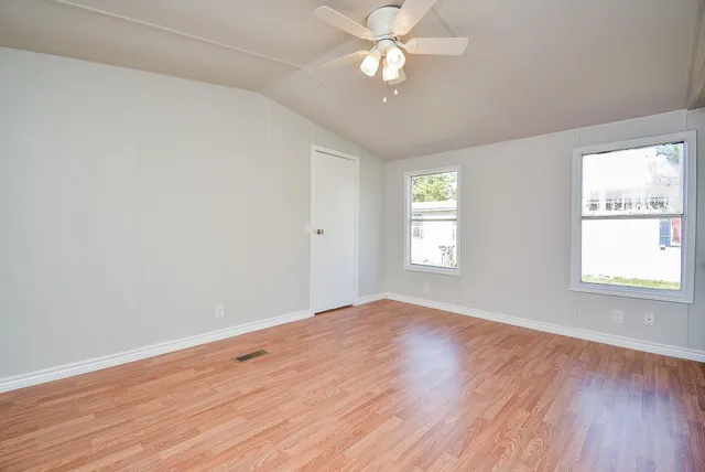 wooden floor in an empty room with a window