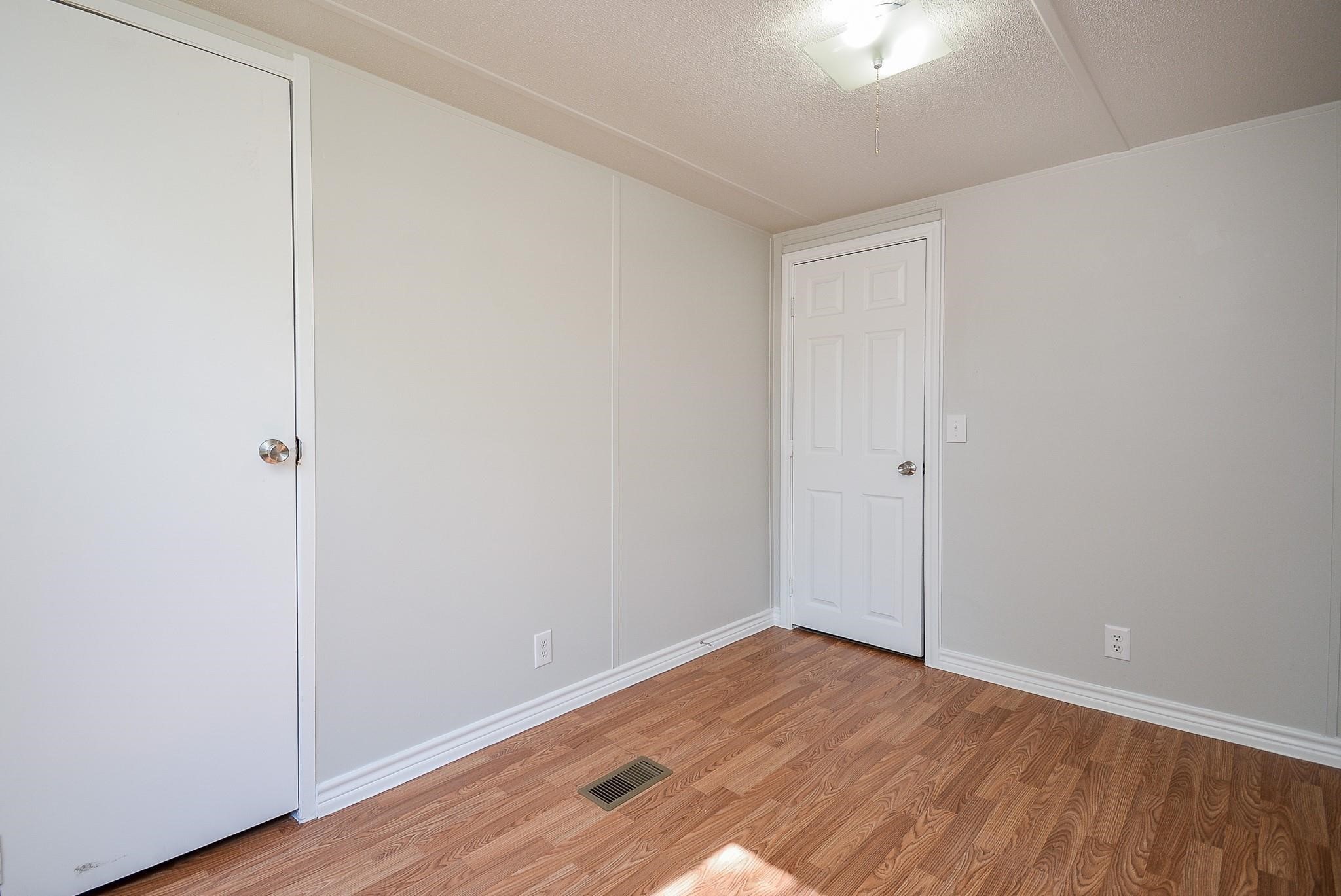 12561 Roy Harris Loop Conroe, TX 77306 - Photo 20 of 31 a view of an empty room with wooden floor
