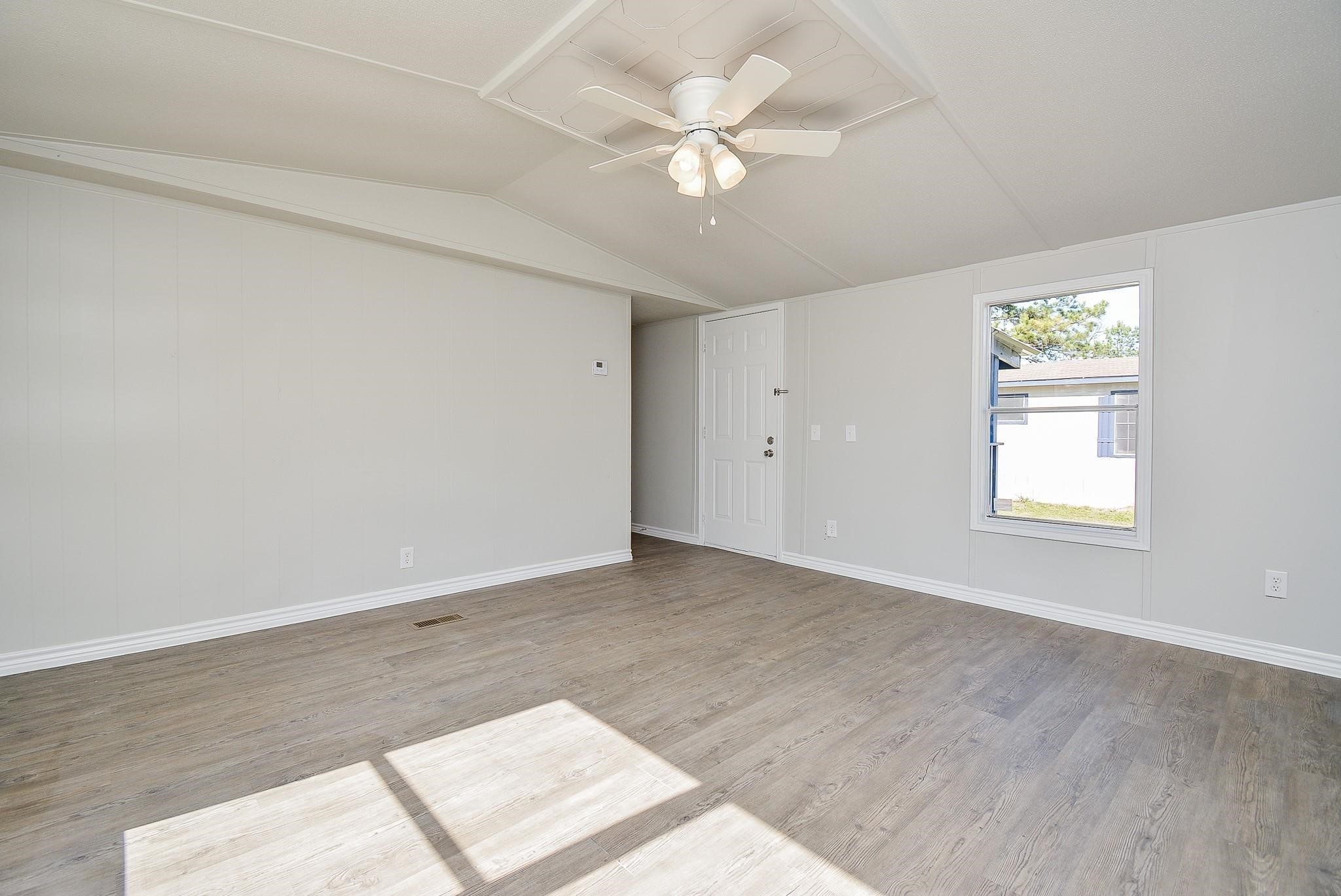 12561 Roy Harris Loop Conroe, TX 77306 - Photo 21 of 31 wooden floor in an empty room with a window