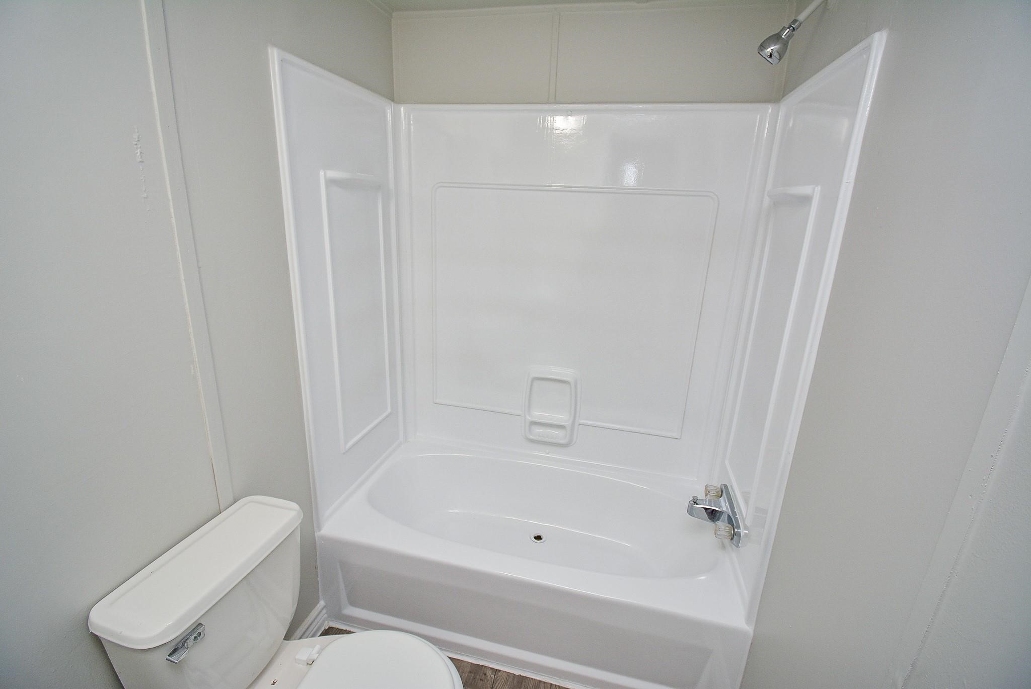 12561 Roy Harris Loop Conroe, TX 77306 - Photo 27 of 31 a bathroom with a toilet and a bathtub