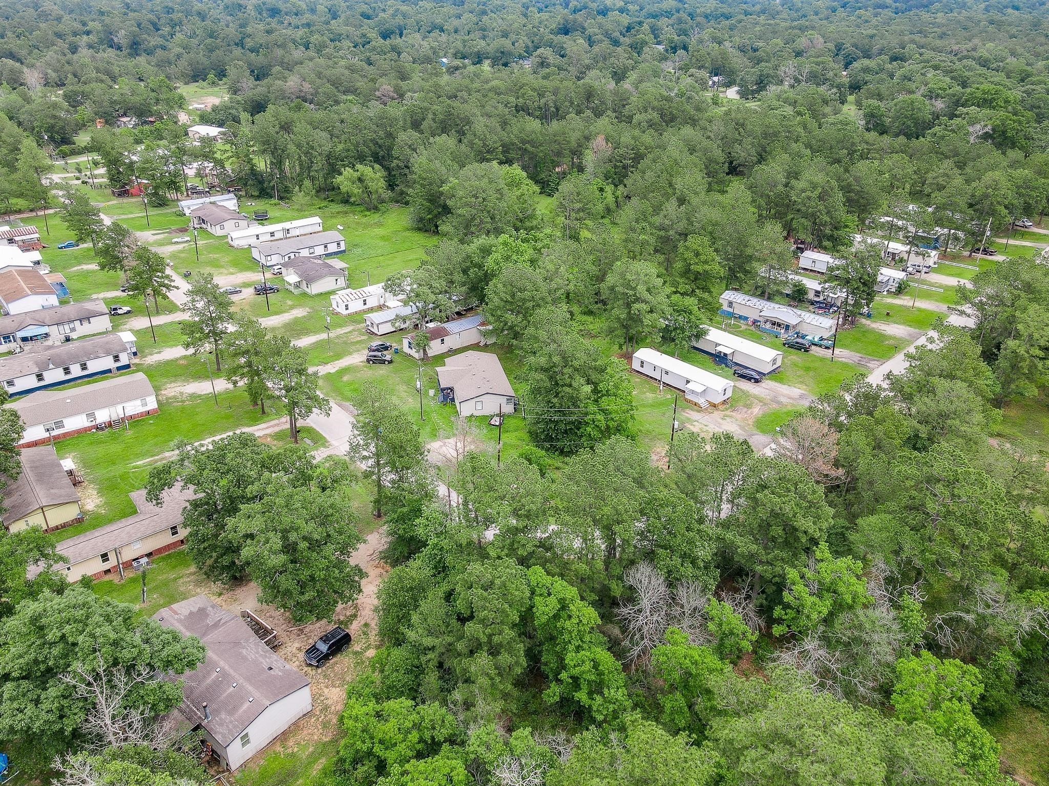 12561 Roy Harris Loop Conroe, TX 77306 - Photo 6 of 31 an aerial view of residential houses with outdoor space and trees