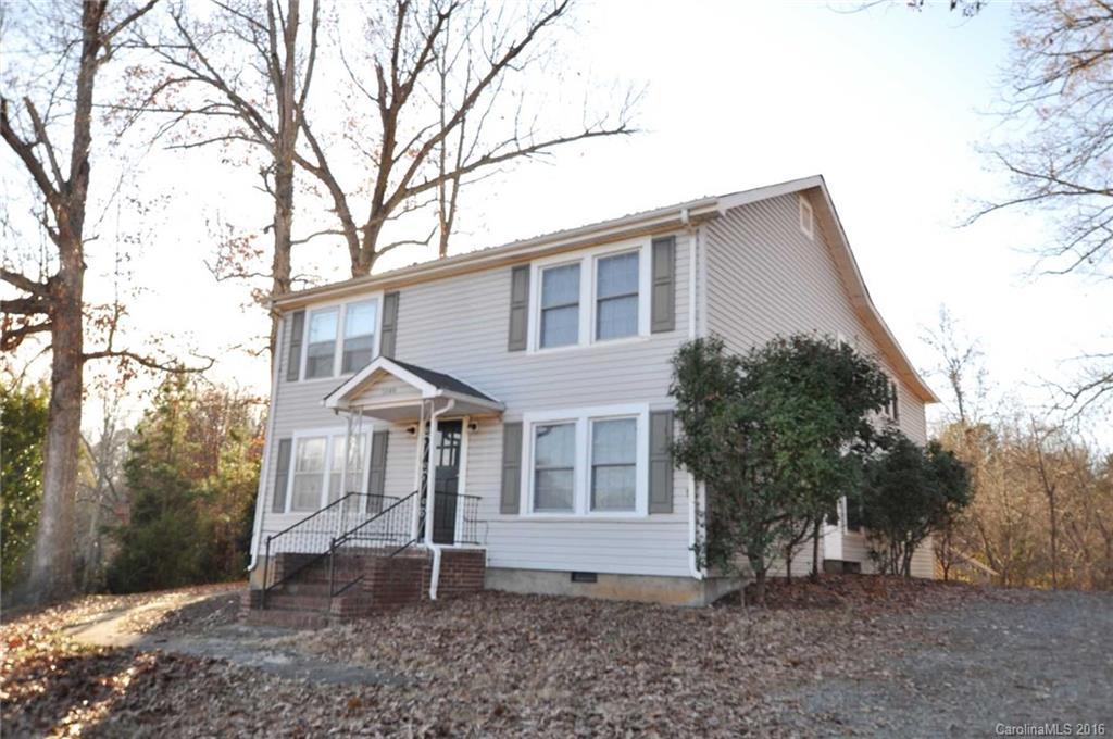 5249 Clearwater Lake Road Mount Holly, NC 28120 - Photo 1 of 16 a front view of a house with garden