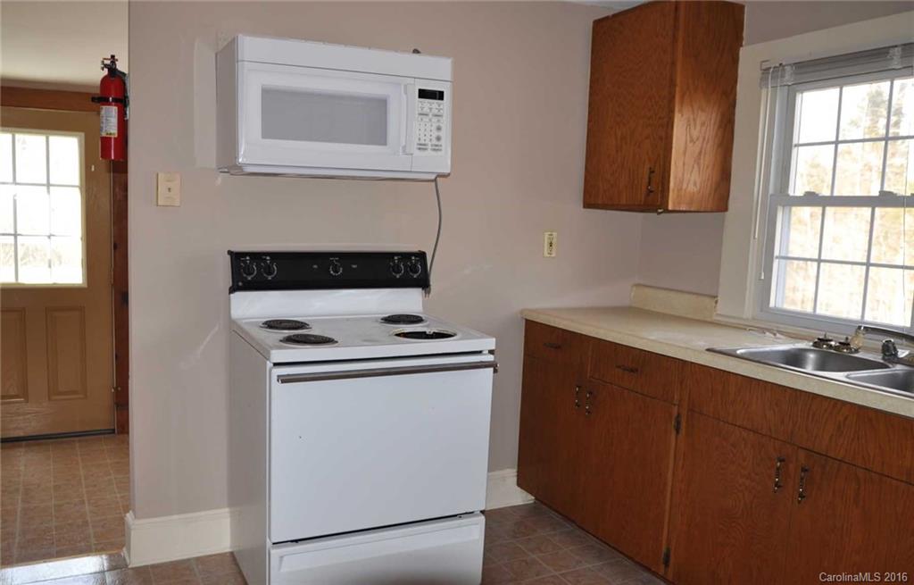 5249 Clearwater Lake Road Mount Holly, NC 28120 - Photo 12 of 16 a kitchen with a stove and a sink
