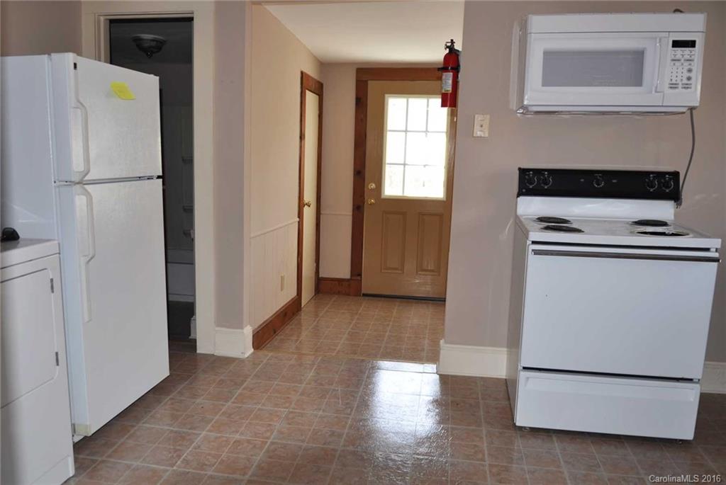 5249 Clearwater Lake Road Mount Holly, NC 28120 - Photo 14 of 16 a view of a kitchen with a refrigerator a microwave and a sink