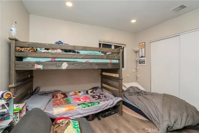 a living room with stainless steel appliances furniture and a kitchen view