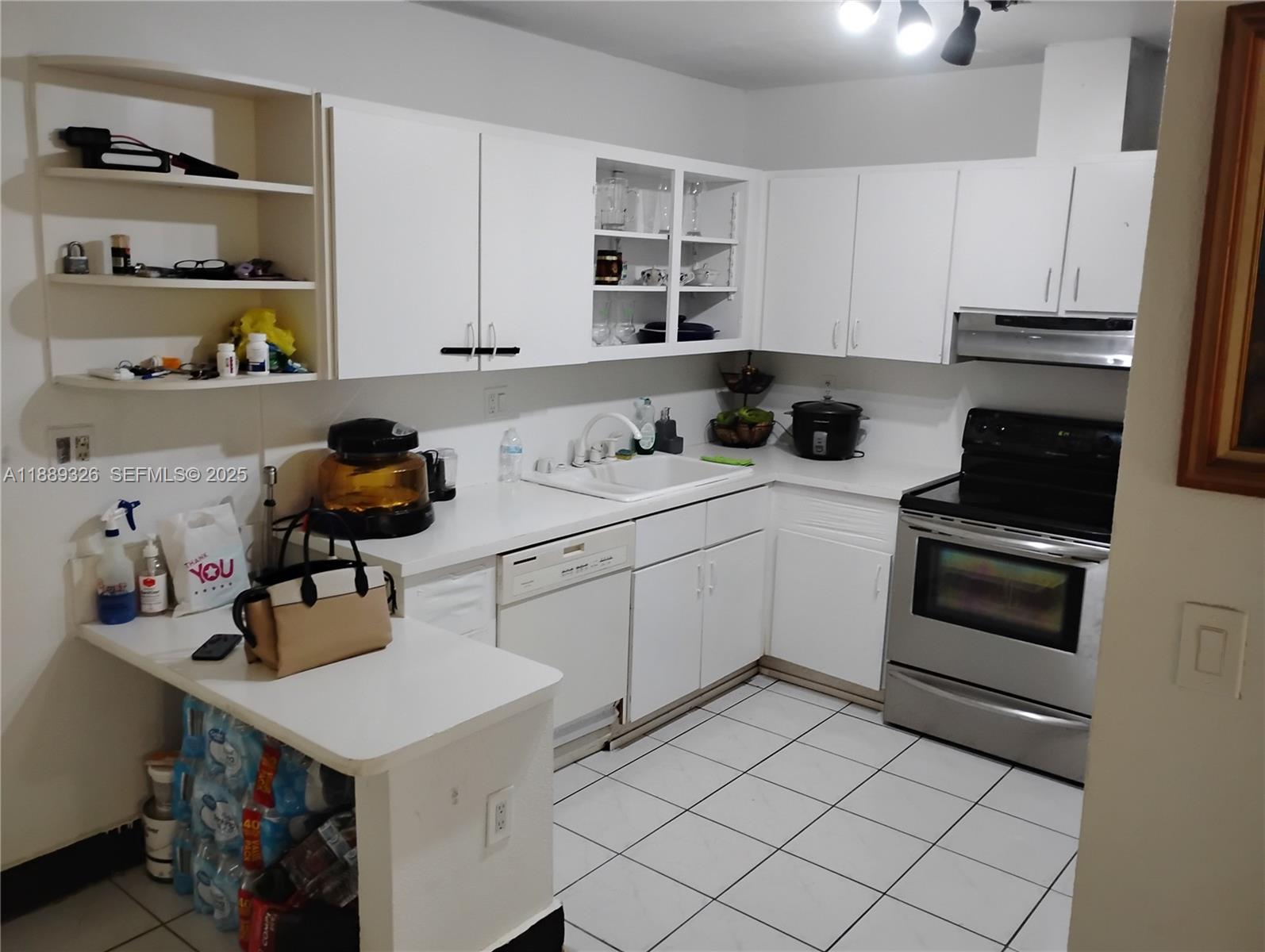 19755 Southwest 190th Street Miami, FL 33187 - Photo 14 of 17 a kitchen with a sink appliances and cabinets
