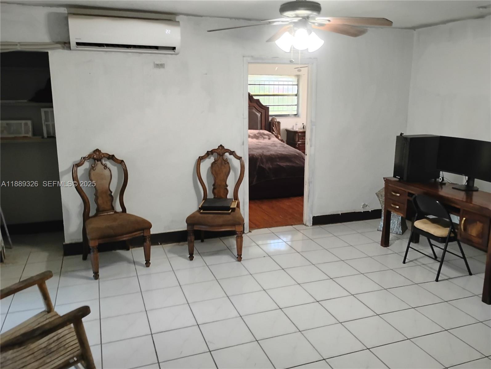 19755 Southwest 190th Street Miami, FL 33187 - Photo 15 of 17 a living room with furniture and a chair