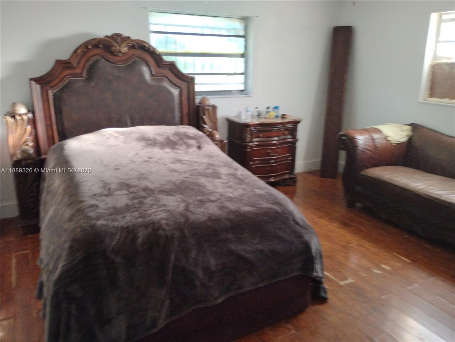 19755 Southwest 190th Street Miami, FL 33187 - Photo 16 of 17 a bedroom with a bed and a couch