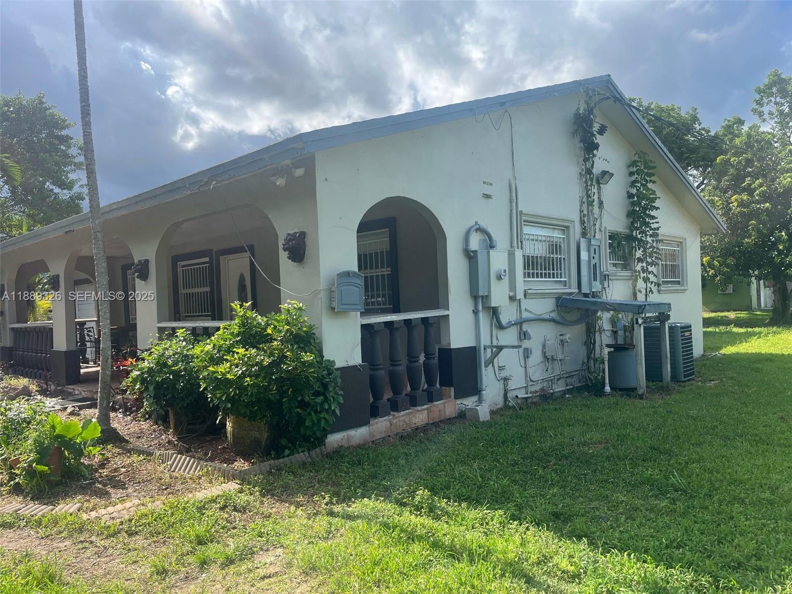 19755 Southwest 190th Street Miami, FL 33187 - Photo 2 of 17 a front view of house with yard