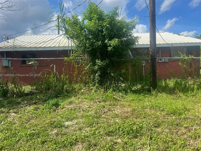 a view of backyard with plants and outdoor seating