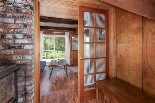 a view of a room with wooden floor and furniture